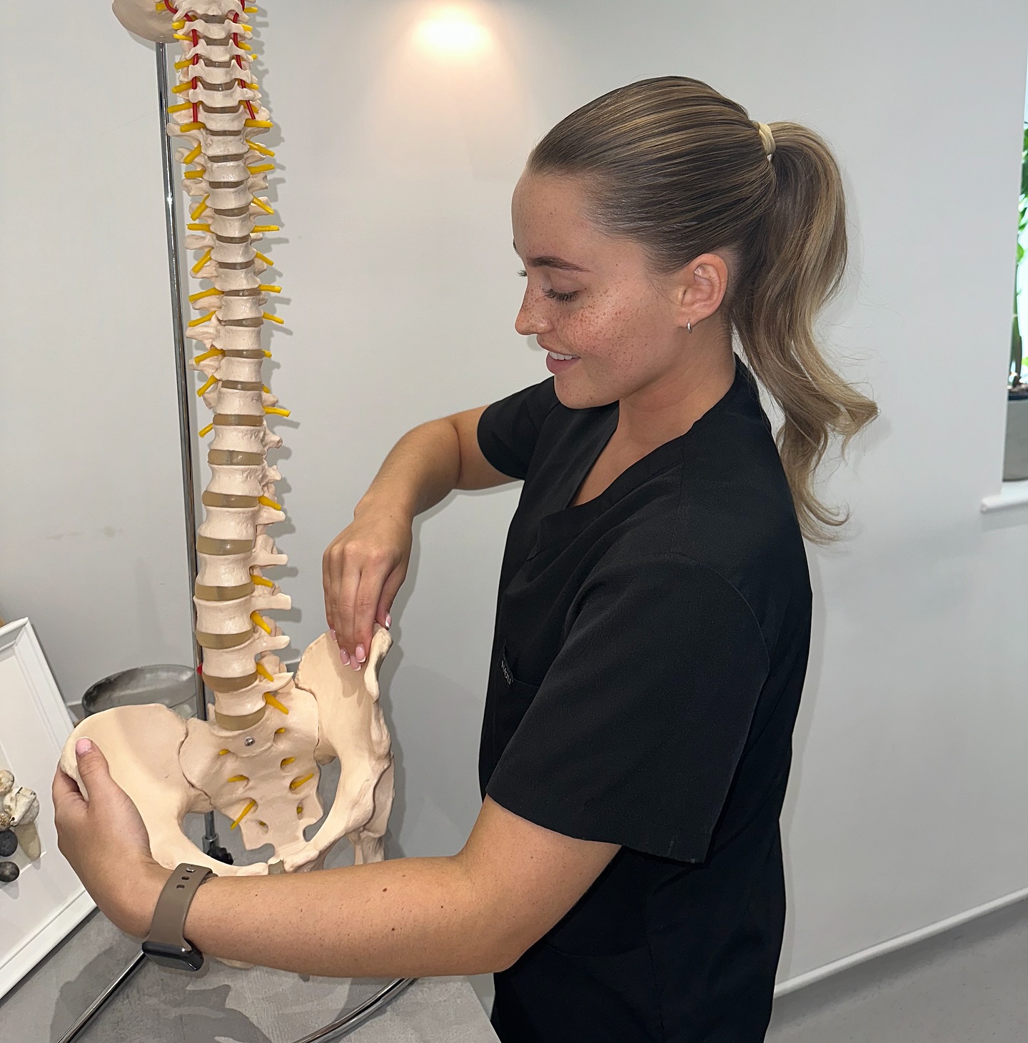 Morgan with a model of the spine and pelvis
